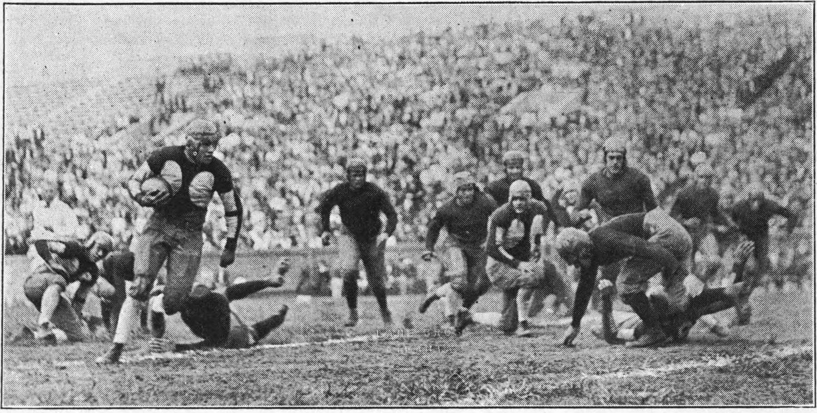 Georgia Tech football player Doug Wycoff with the ball, rushing against the Oglethorpe Stormy Petrels during their 1925 football game.