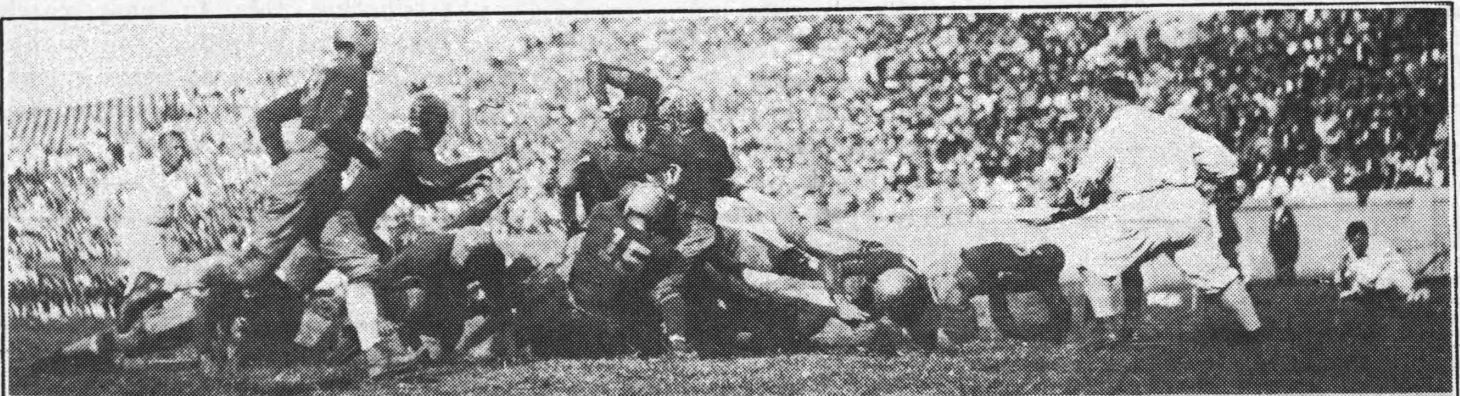 Georgia Tech Golden Tornado player Carter Barron goes through the center during a football game against VMI in 1925.