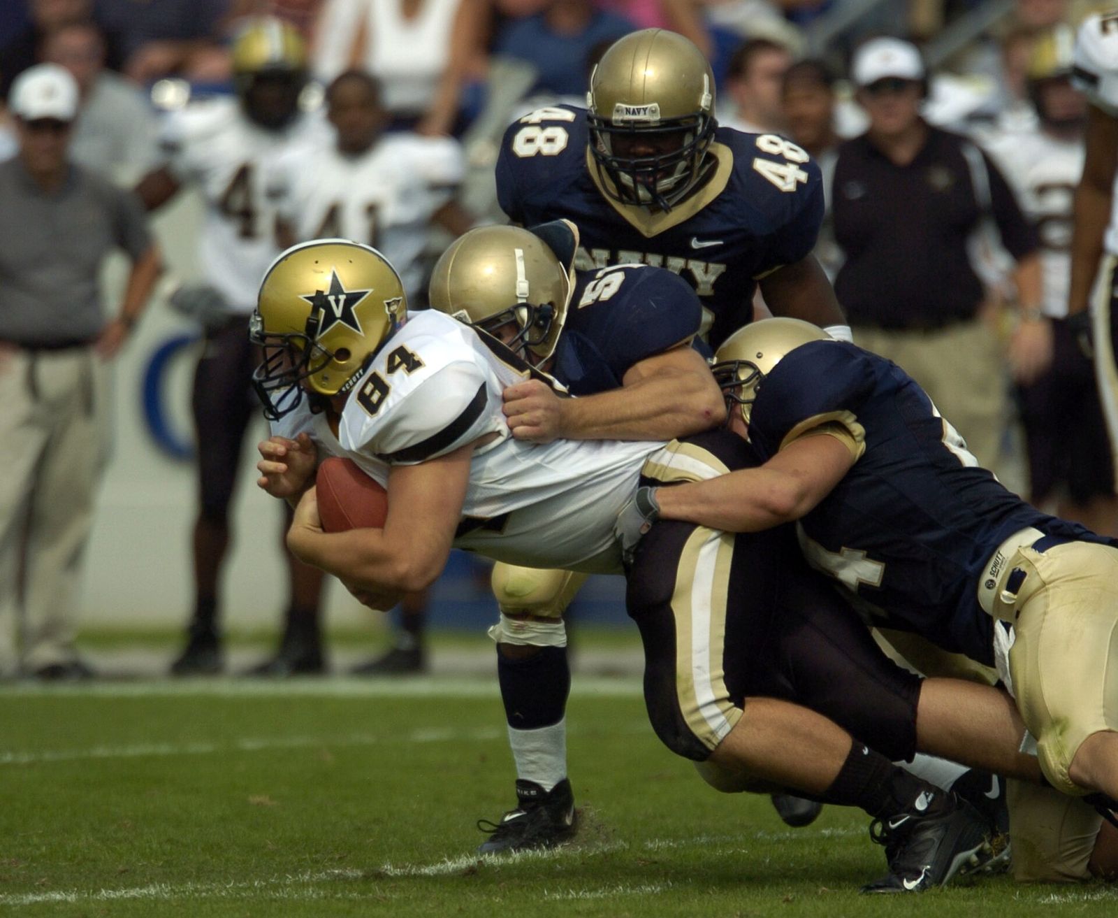 Vanderbilt tight end Dustin Dunnning is tackled by U.S. Naval Academy Midshipmen Bobby McLarin, center, and Lane Jackson, right.