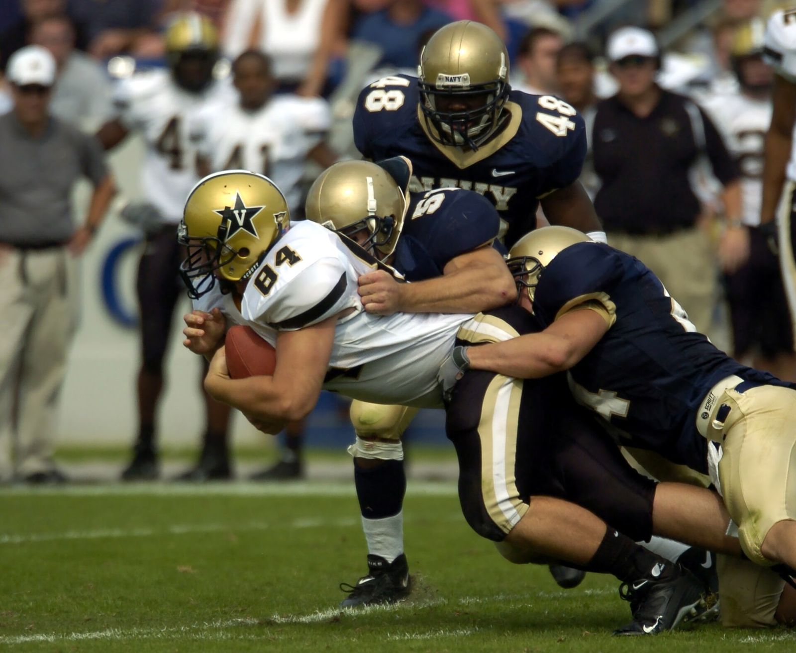 Vanderbilt tight end Dustin Dunnning is tackled by U.S. Naval Academy Midshipmen Bobby McLarin, center, and Lane Jackson, right.