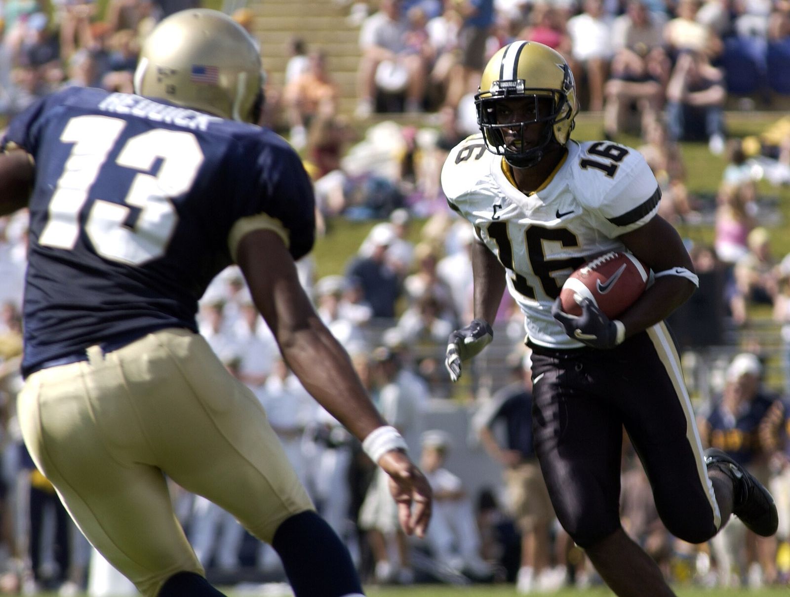 Vanderbilt wide receiver Chris Young attempts to evade U.S. Naval Academy Midshipman 3rd Class Hunter Reddick.