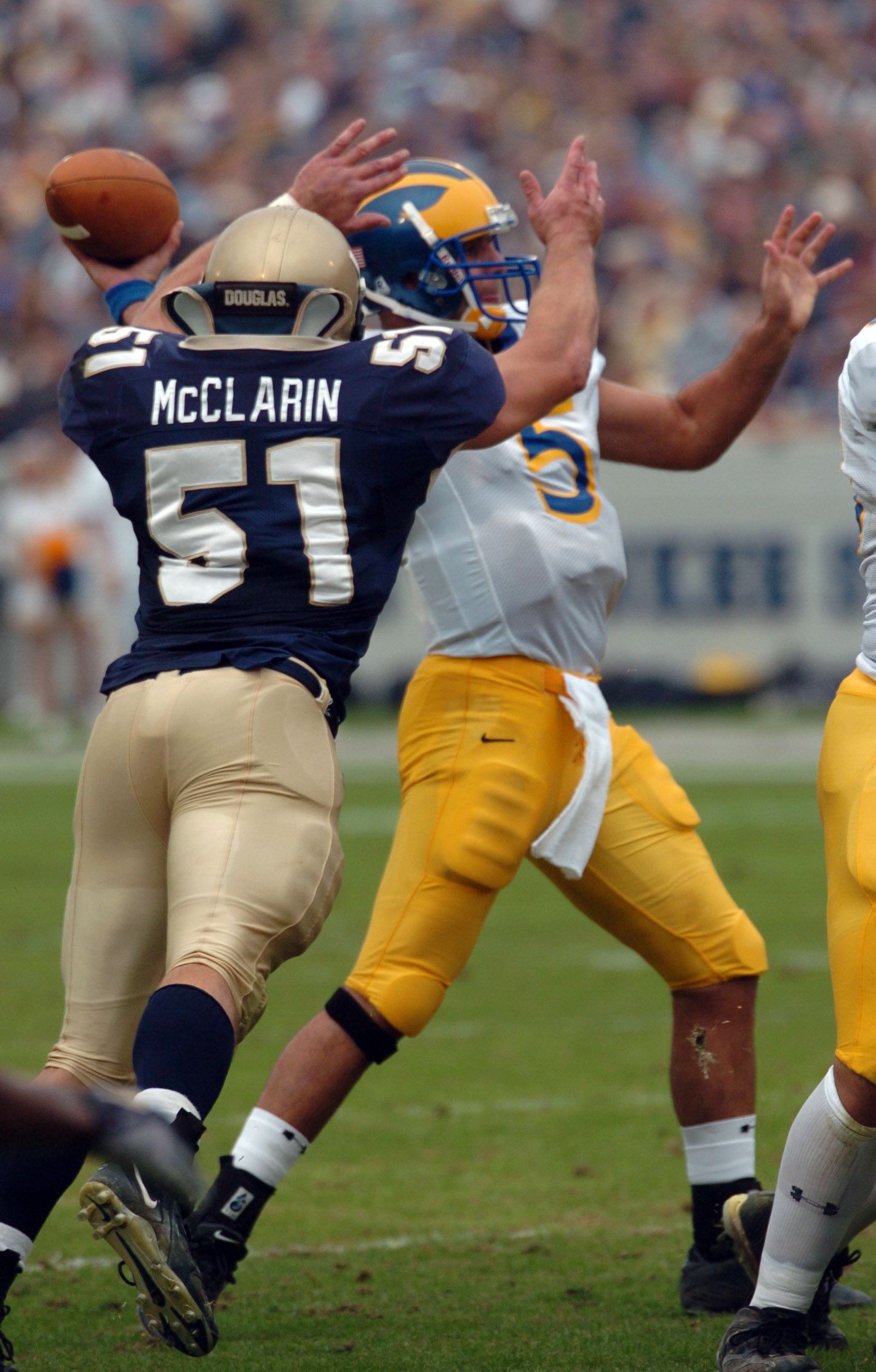 U.S. Naval Academy Midshipman 1st Class Bobby McClarin tries to block a pass by Delaware Blue Hen's Quarterback Sonny Riccio during the 1st quarter of play.