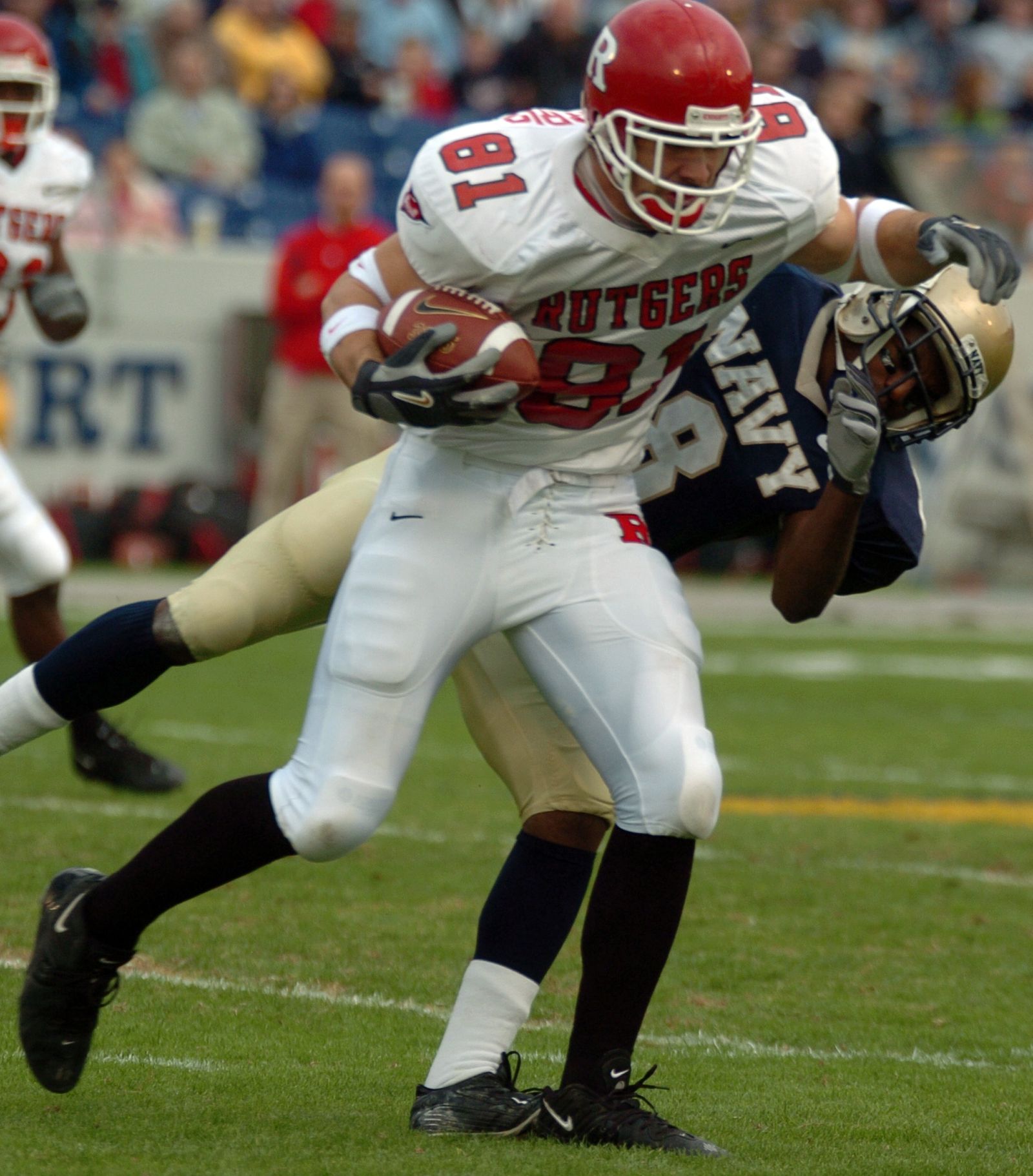 U.S. Naval Academy Midshipman 3rd Class Jeremy McGown tackles Rutgers University quarterback Terrance Shawell in the 1st half of play.
