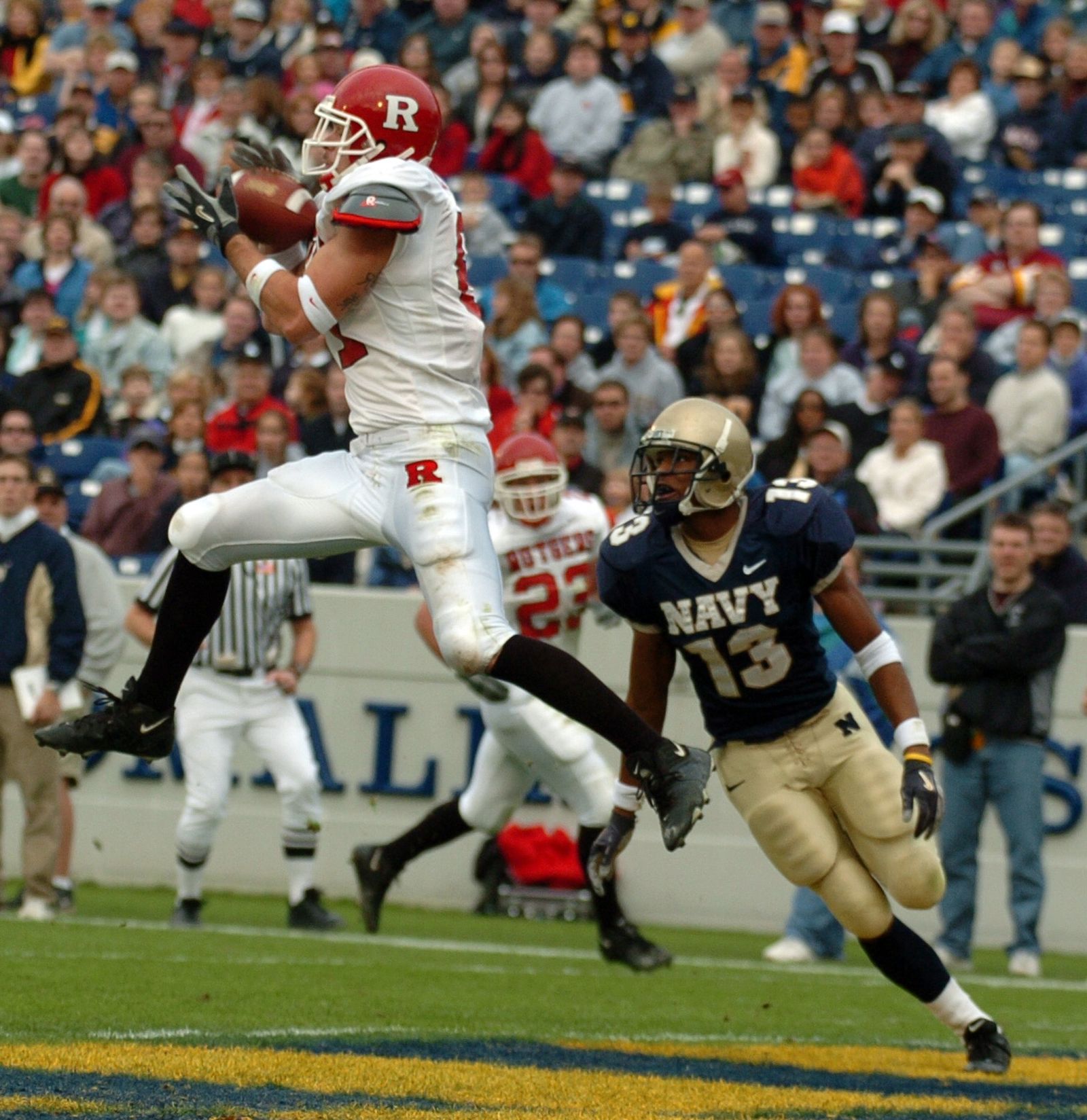 Rutgers University tight end Clark Harris catches a pass from quarterback Ryan Hart under coverage by U.S. Naval Academy Midshipman 3rd Class Hunter Reddick.