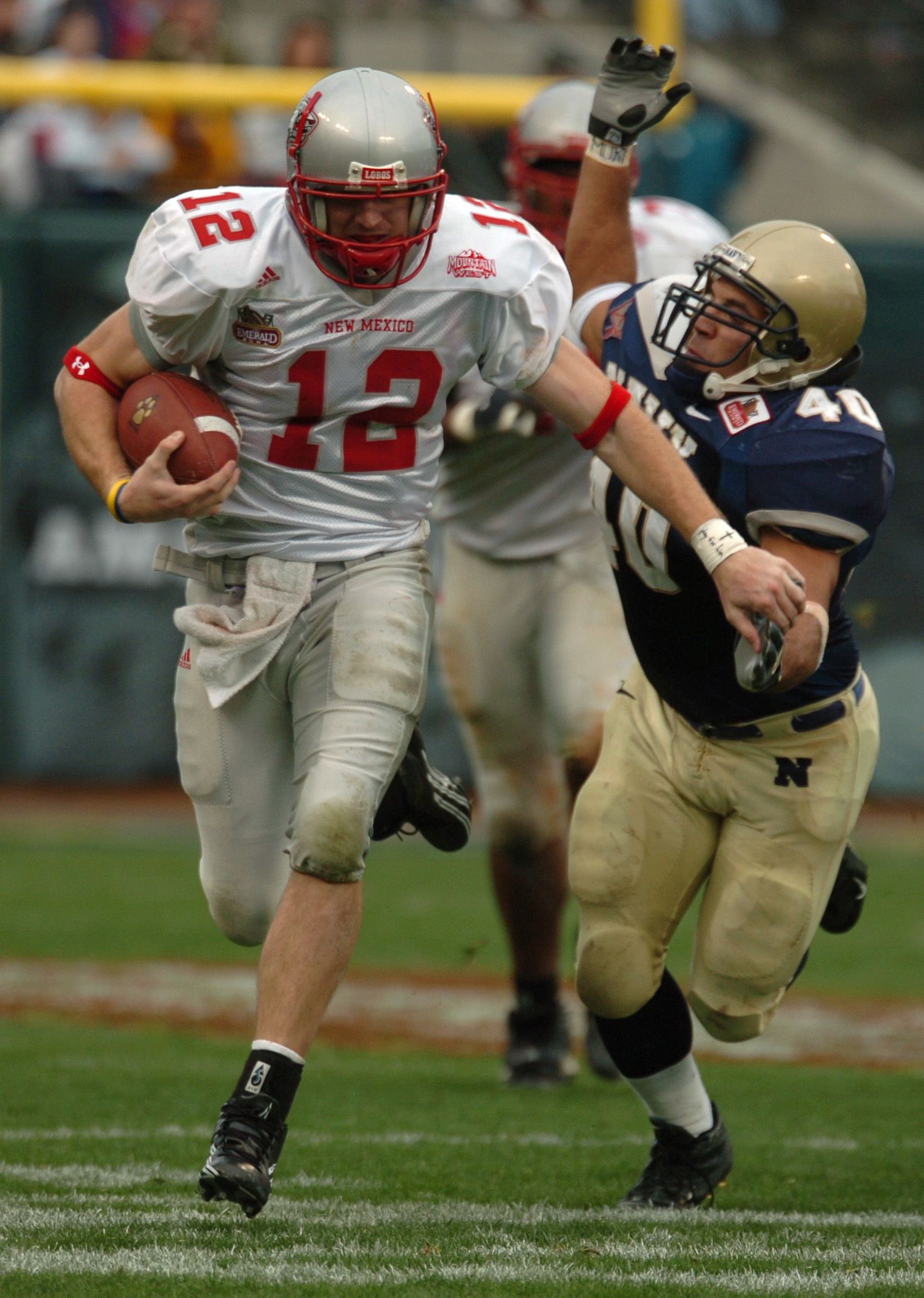 U.S. Naval Academy Midshipman line backer David Mahoney attempts to tackle New Mexico quarterback Kole McKamey.