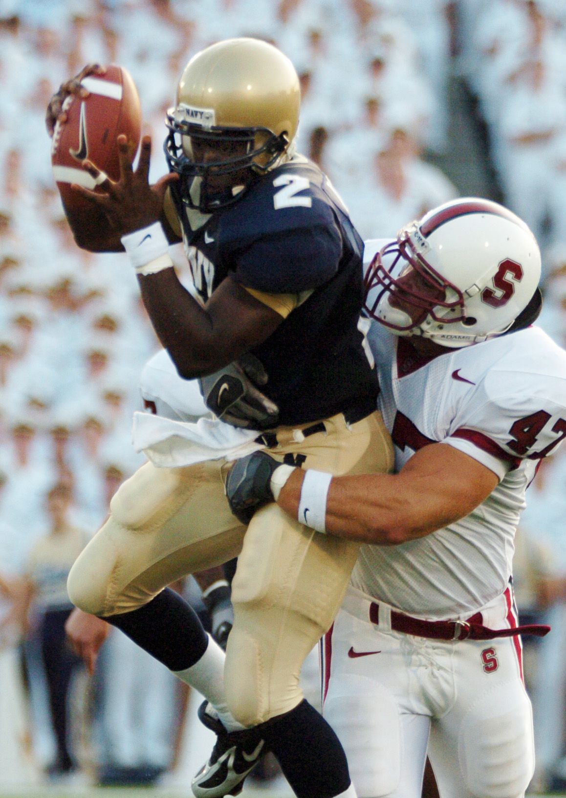 U.S. Naval Academy Midshipmen Quarterback Lamar Owens is sacked by Stanford Cardinal linebacker Kevin Schimmelmann.