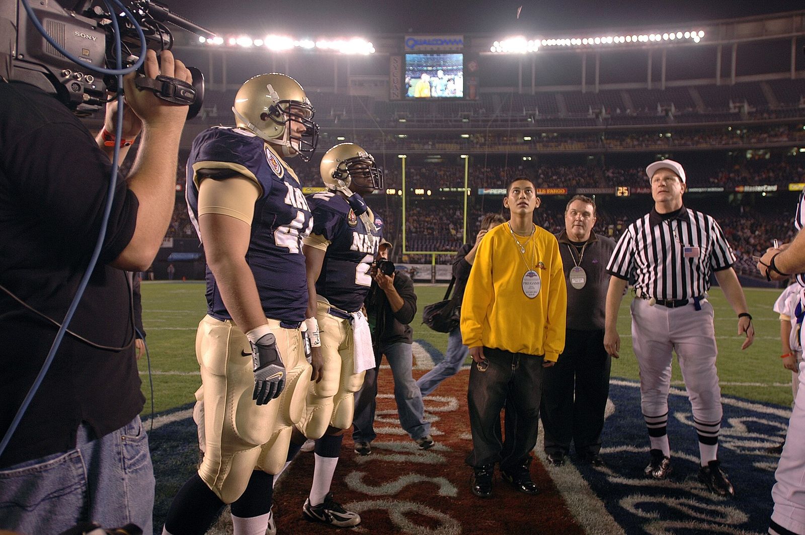 U.S. Naval Academy defensive end (DE) Jeremy Chase and Quarterback (QB) Lamar Owens look on as a coin is flipped at the start of the inaugural Poinsettia Bowl.