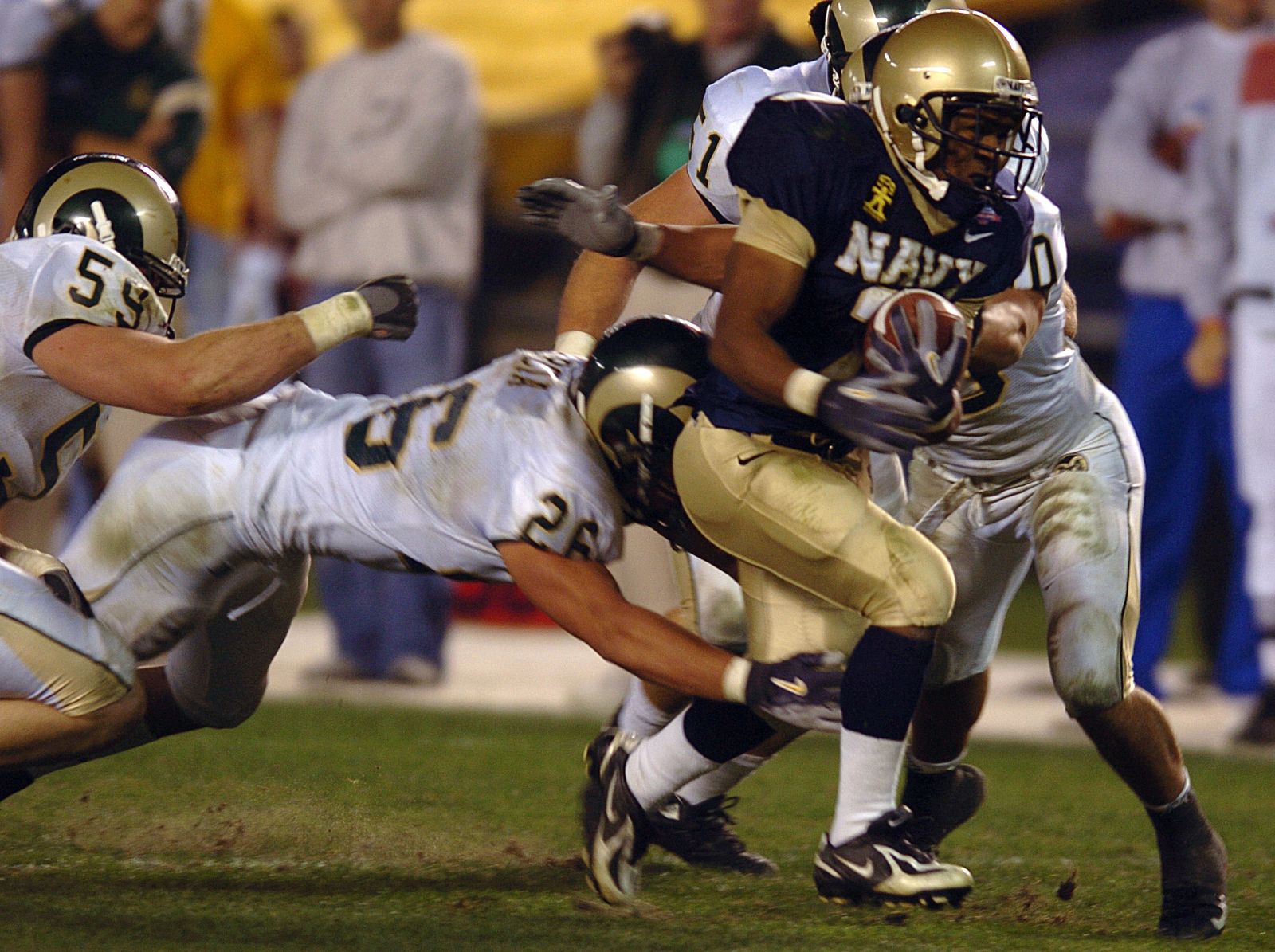 U.S. Naval Academy slot back Reggie Campbell runs for a touchdown as four Colorado State Rams try to stop him.
