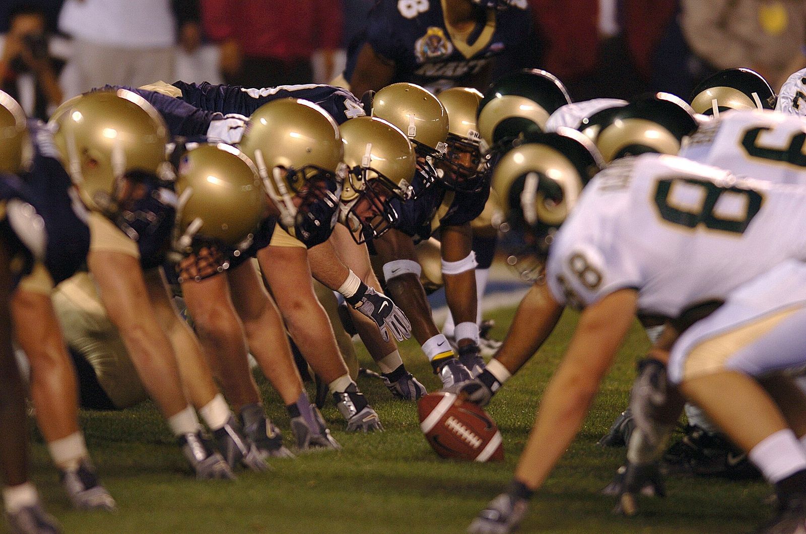 The U.S. Naval Academy Midshipmen position themselves defensively in preparation for a play by the Colorado State Rams.