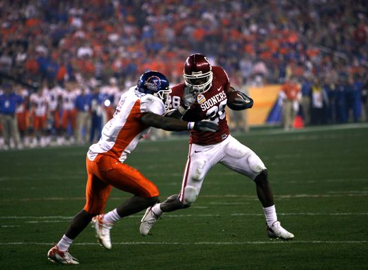 Running back Adrian Peterson runs by Boise State's Gerald Alexander during the 2007 Fiesta Bowl.adrian peterson