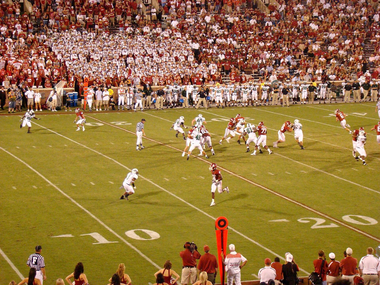 The Oklahoma Sooners football team takes on the North Texas Mean Green. Keith Nichol (#6) is playing quarterback for Oklahoma.