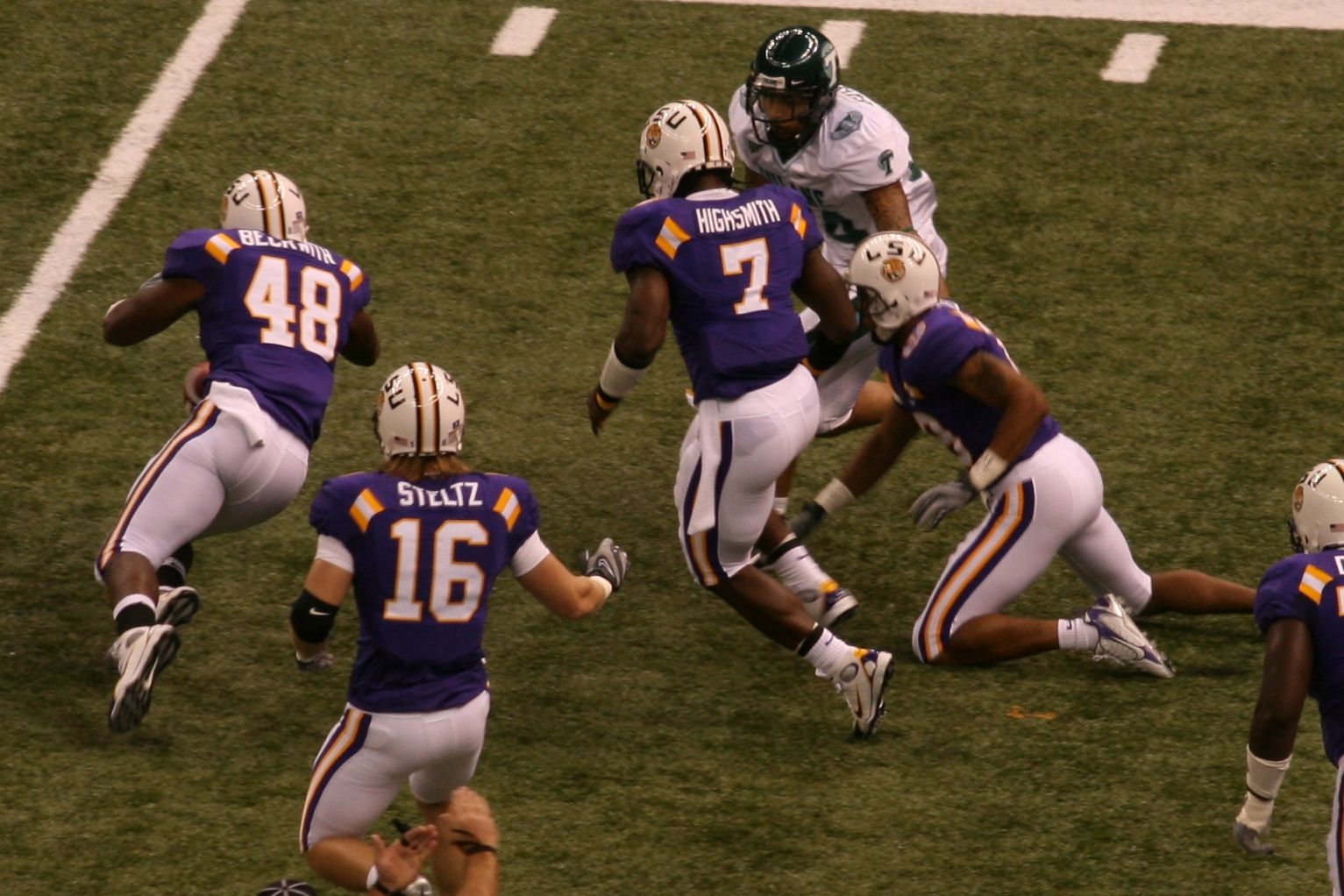 LSU Tigers football team on defense during a game against rival Tulane Green Wave.