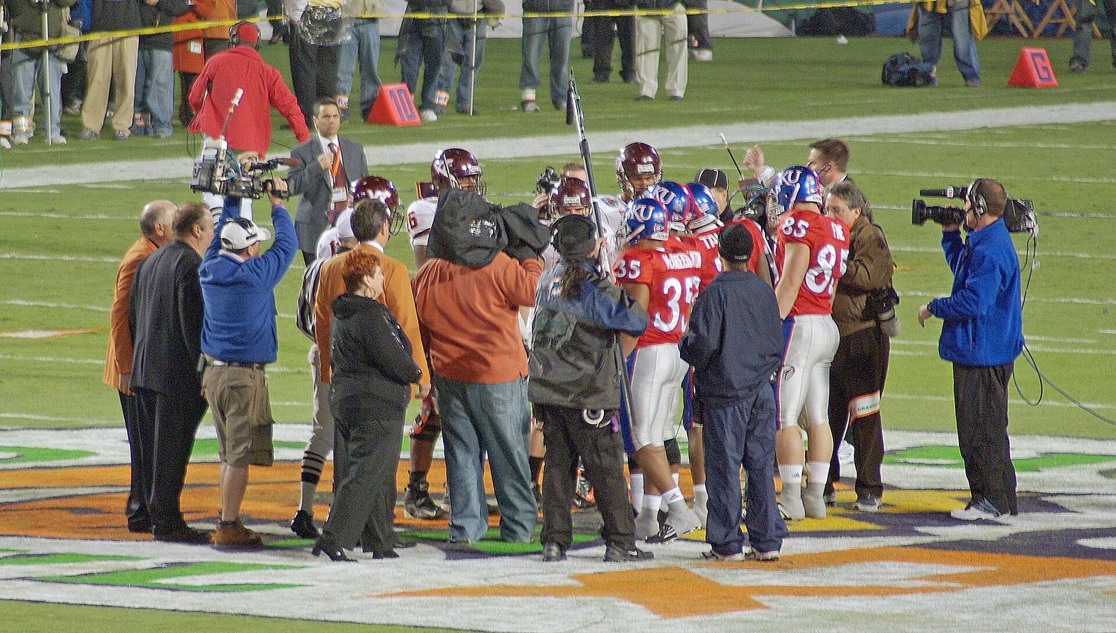 Team captains from Virginia Tech and Kansas gather at midfield prior to kickoff for the ceremonial coin toss before the 2008 Orange Bowl.