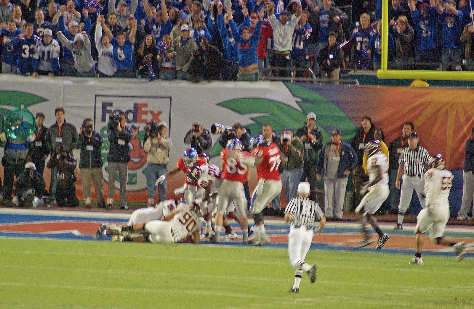 Kansas's offense rushes straight ahead for a short gain and a touchdown.