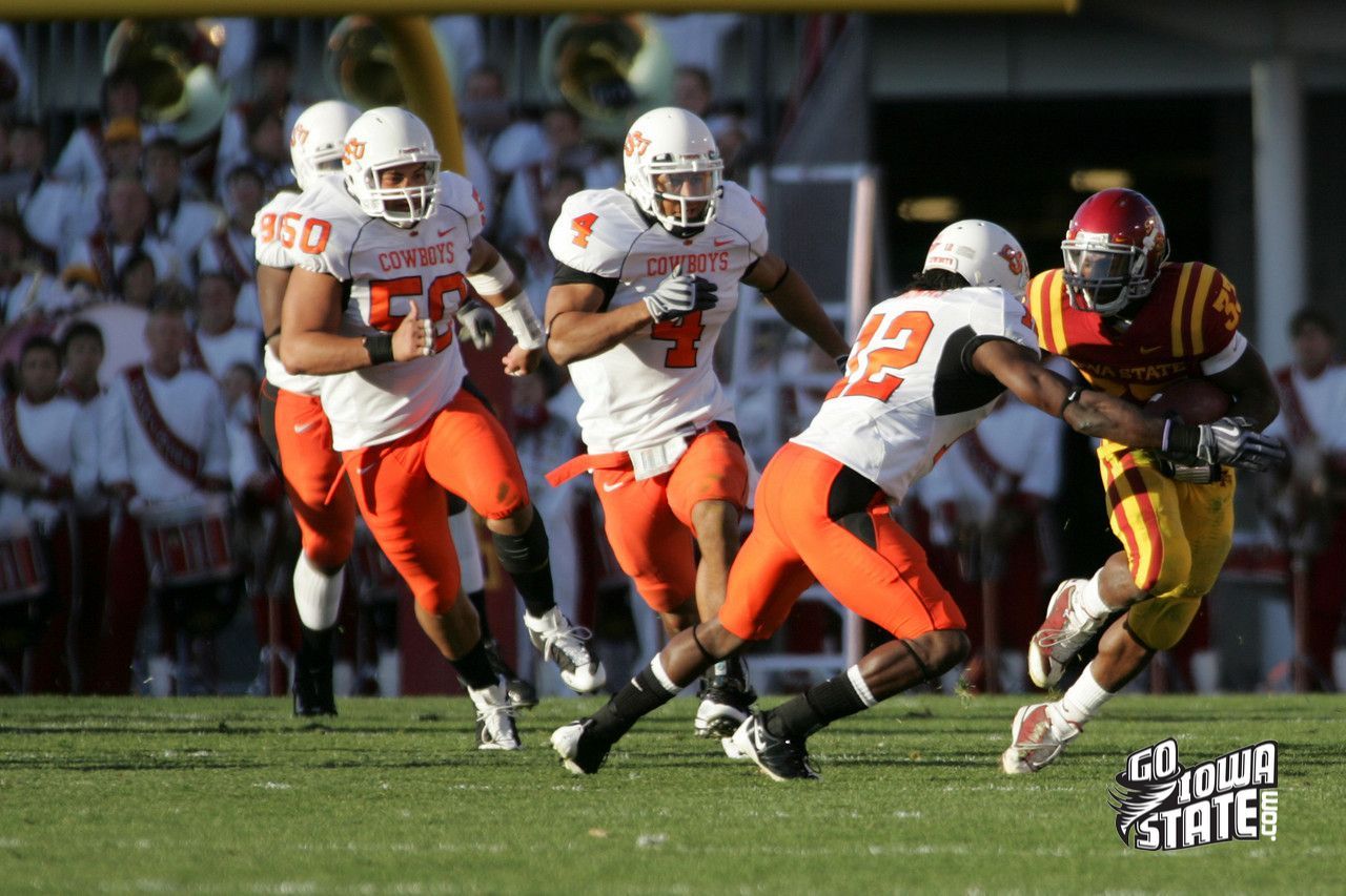 ARob uses a stiff arm on a Cowboy defender