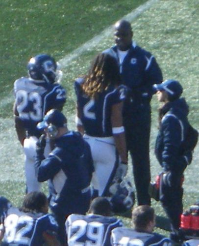 Connecticut running backs Jordan Todman (left) and Andre Dixon (center) talk to running backs coach Terry Richardson (top) during the 2010 PapaJohns.com Bowl.