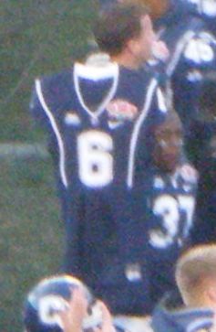 Number 37 (either Jonathan Jean-Louis or Joss Tillard) hold aloft Jasper Howard's #6 jersey following Connecticut's win in the 2010 PapaJohns.com Bowl.