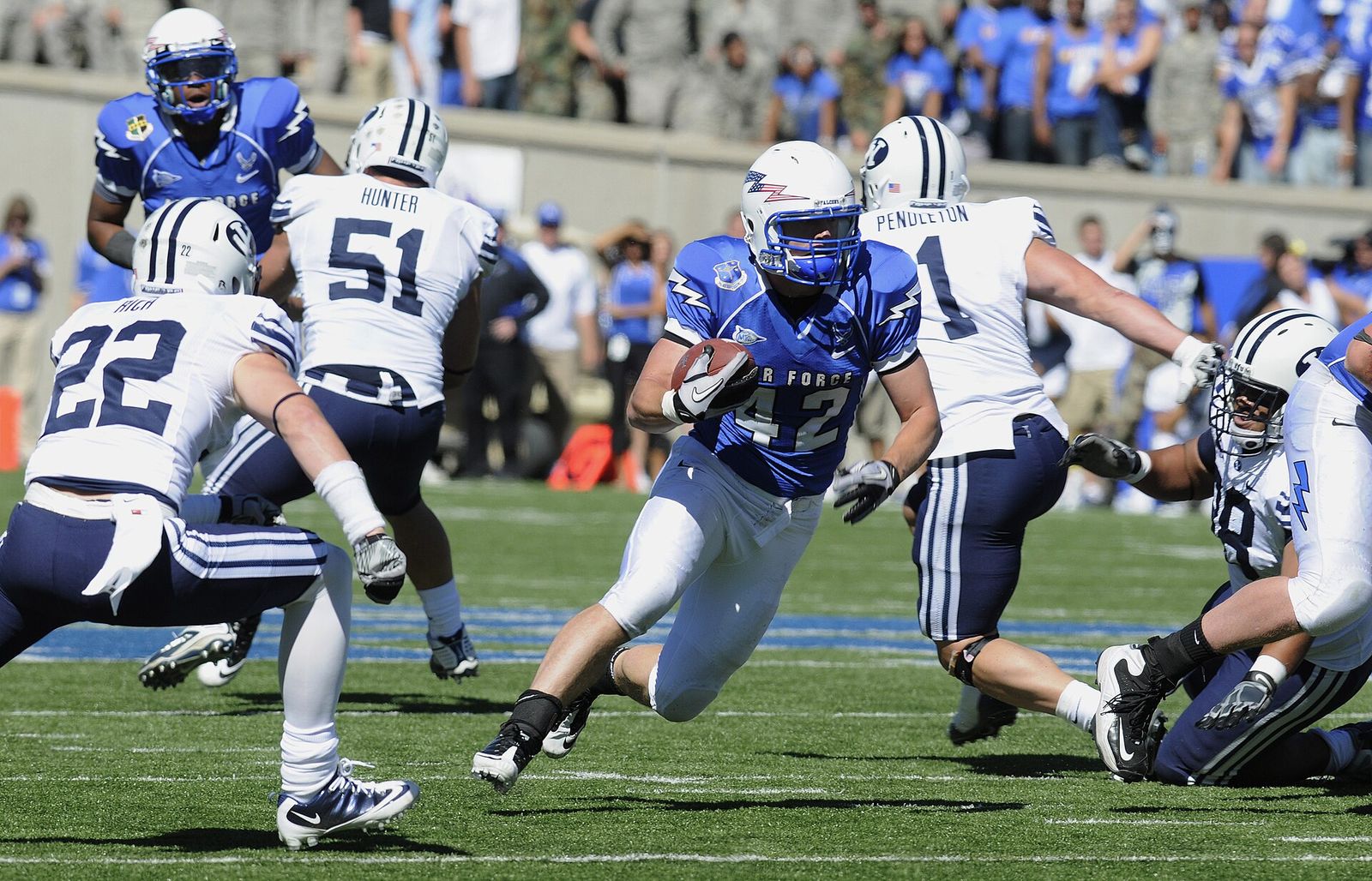 Falcons running back Jared Tew breaks through the Cougars' defensive line during the Air Force-BYU game at Falcon Stadium. The Falcons won 35-14.