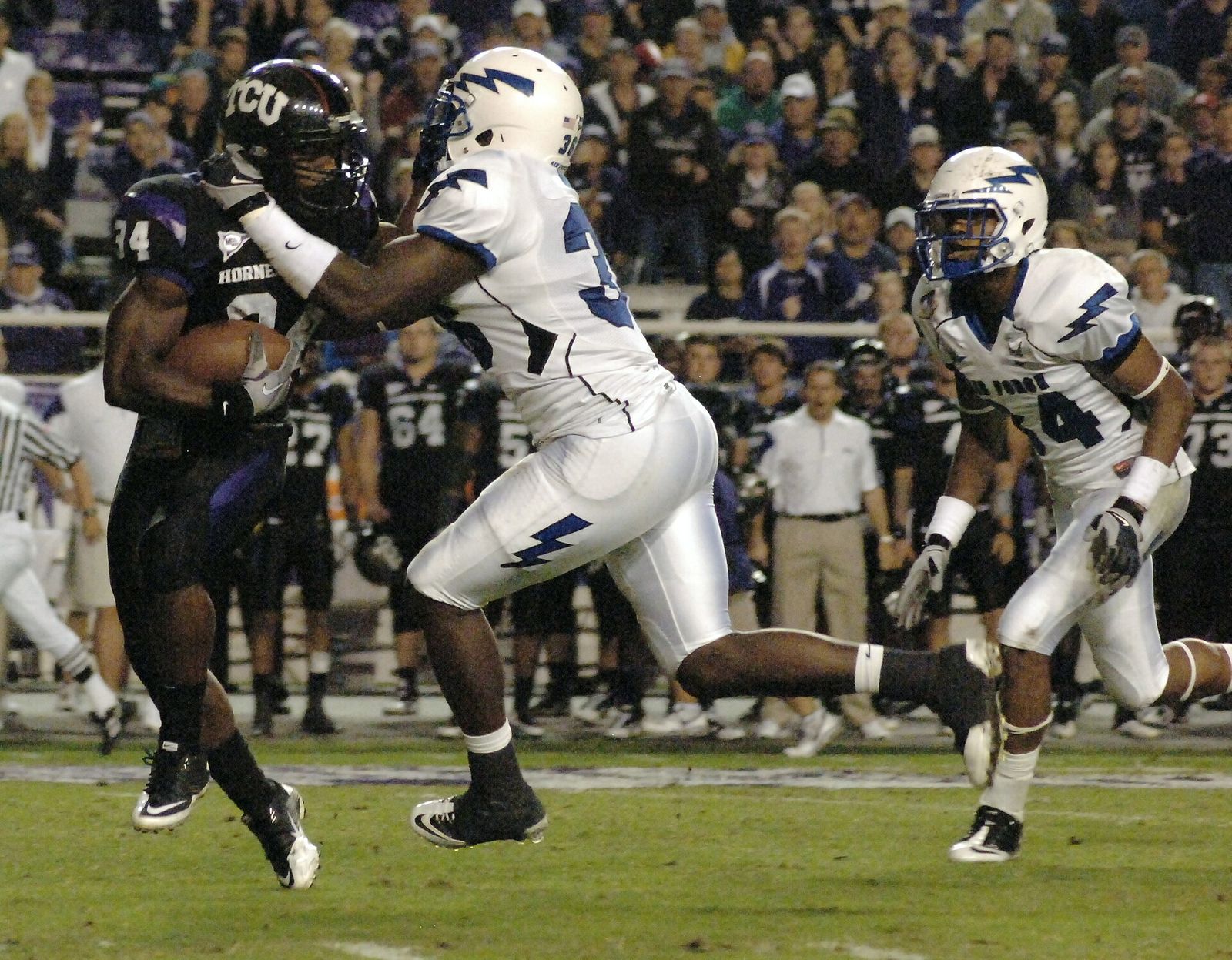 Air Force outside linebacker Andre Morris, Jr. tackles TCU tailback Ed Wesly in the open at Amon G. Carter Stadium in Fort Worth, Texas. TCU won 38-7.
