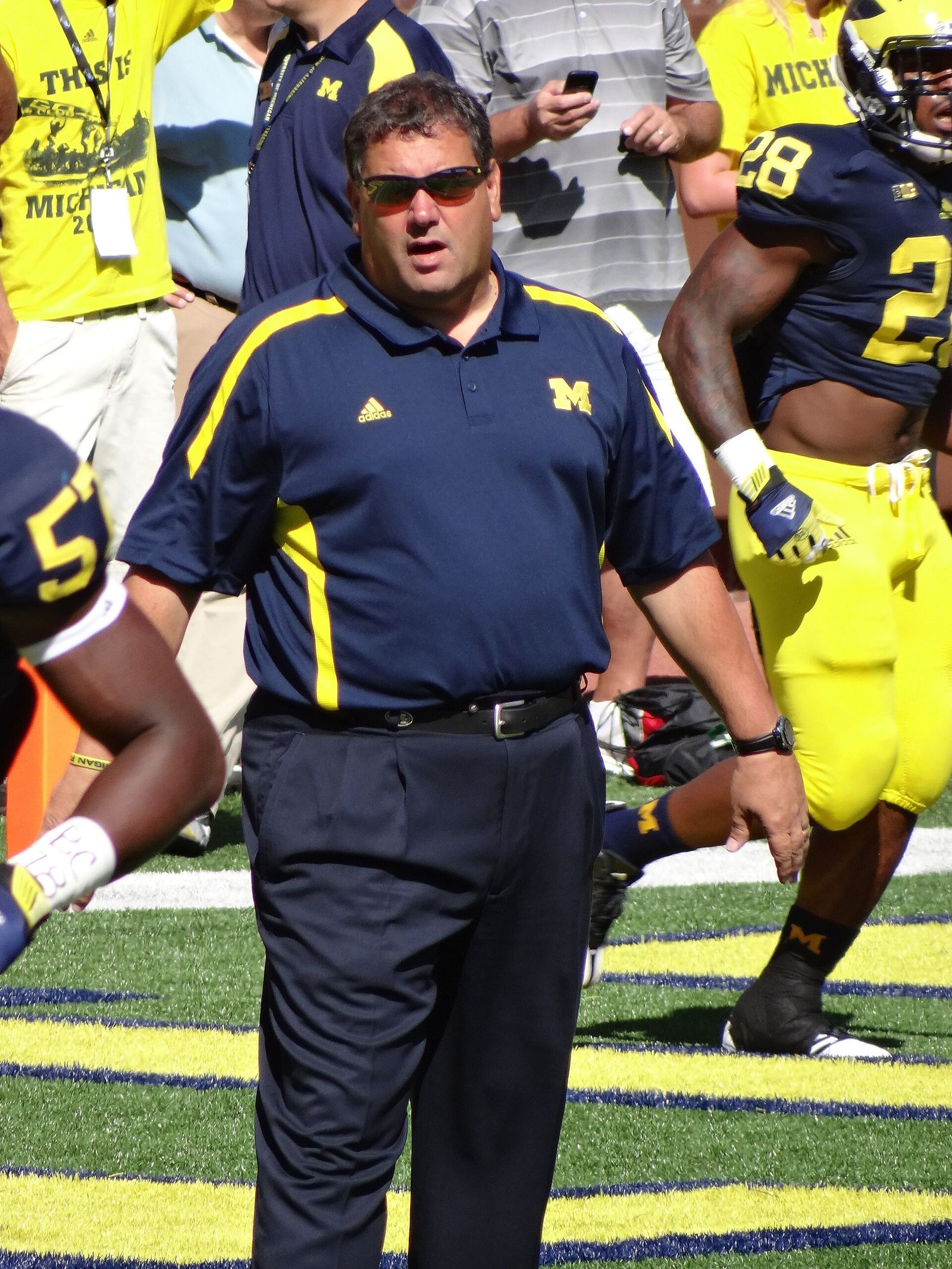 Michigan head coach Brady Hoke (center) and running back Fitzgerald Toussaint (behind at right)