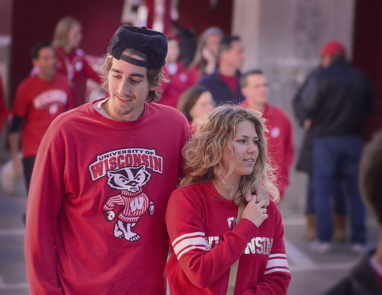 Young couple on their way into Camp Randall Stadium in Madison Wisconsin to watch a Badger football game