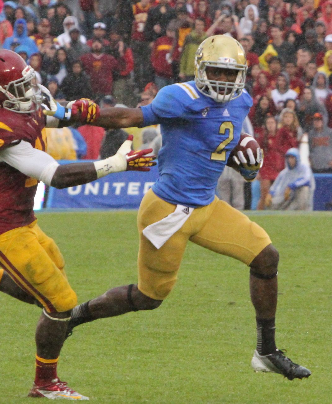 Devin Fuller of UCLA with ball against Dion Bailey of USC