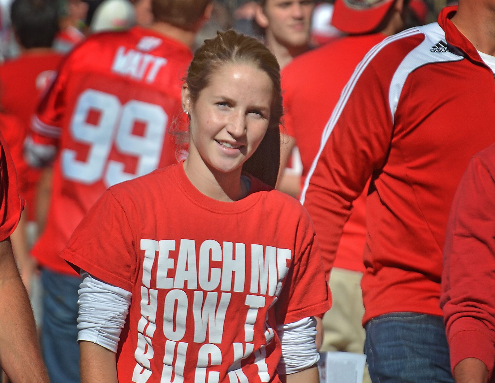 Young woman in the crowd of Badger fans outside Camp Randall Stadium in Madison, Wisconsin prior to the start of a football game