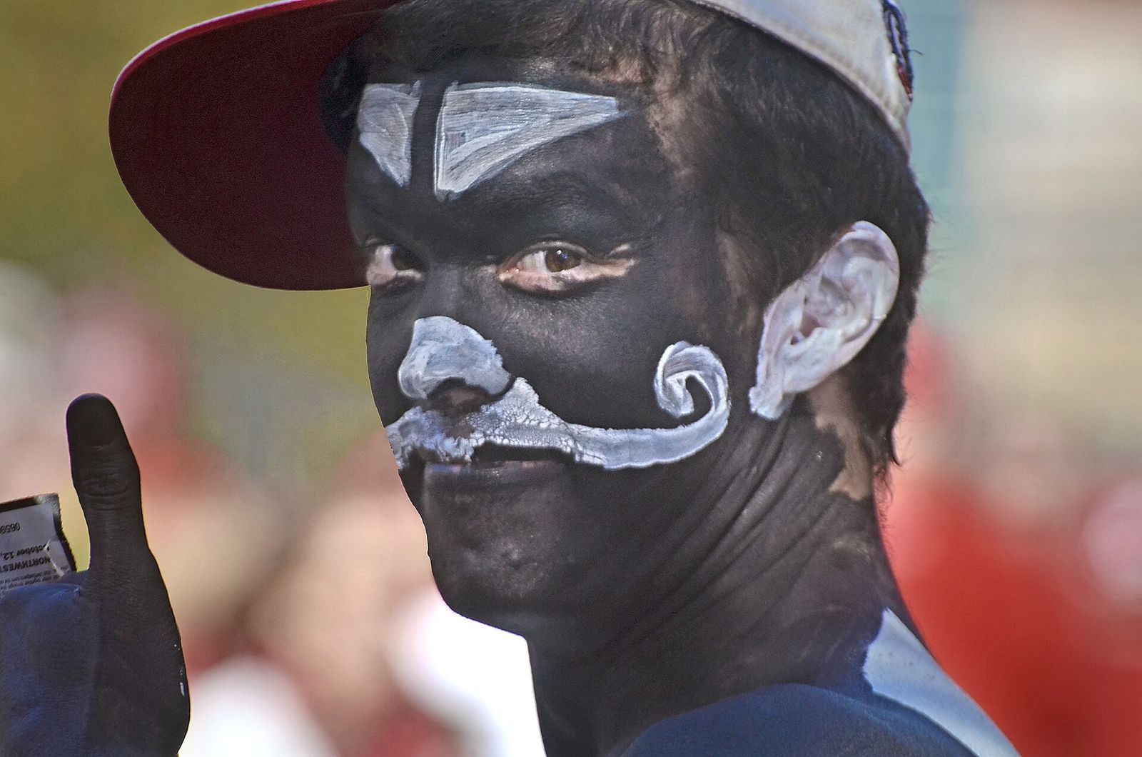 Northwestern Wildcat fan in the crowd outside Camp Randall Stadium in Madiso prior to the start of a Wisconsin Badgers football game