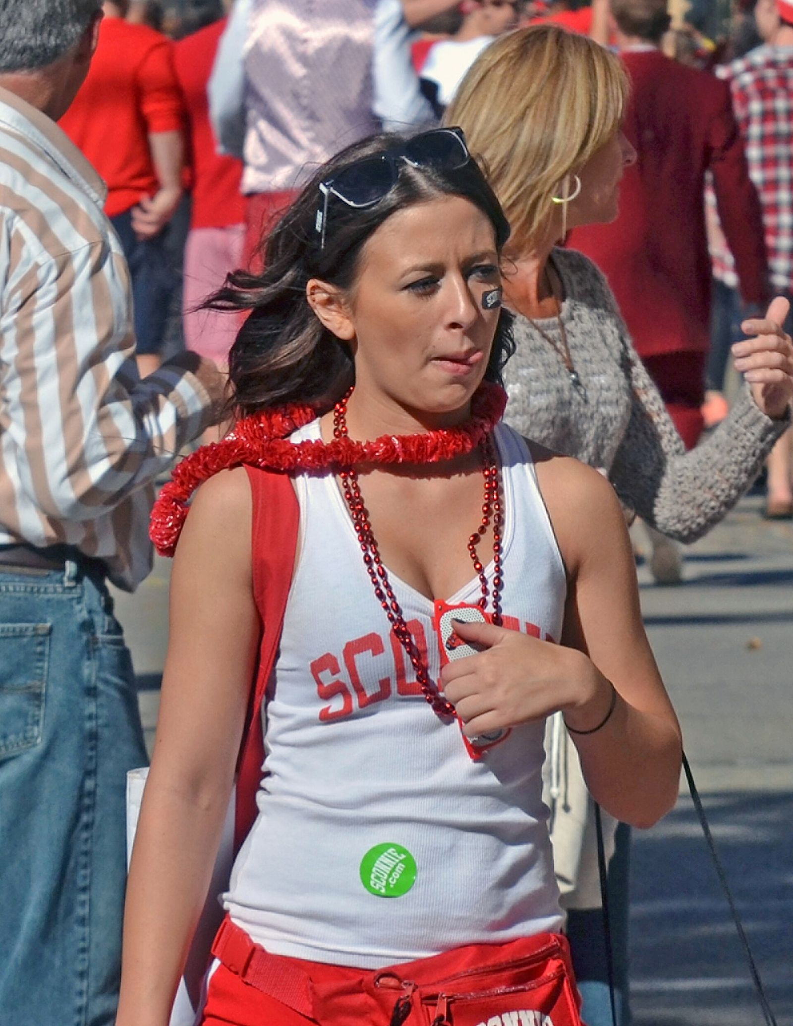 Young woman in the crowd of Wisconsin Badgers football fans outside Camp Randall Stadium in Madison prior to the start of a football game