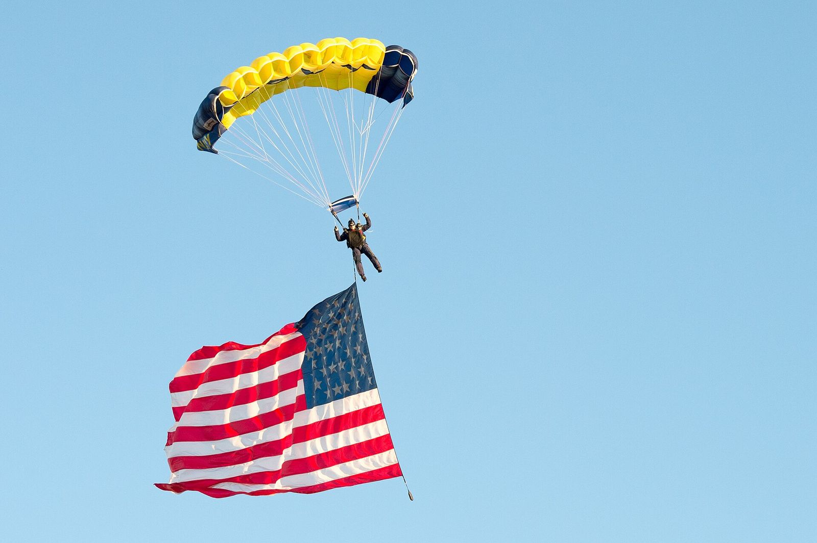 A U.S. Sailor with the Leap Frogs parachutes onto the field at Notre Dame Stadium in South Bend, Ind., Sept. 6, 2014, before a football game.