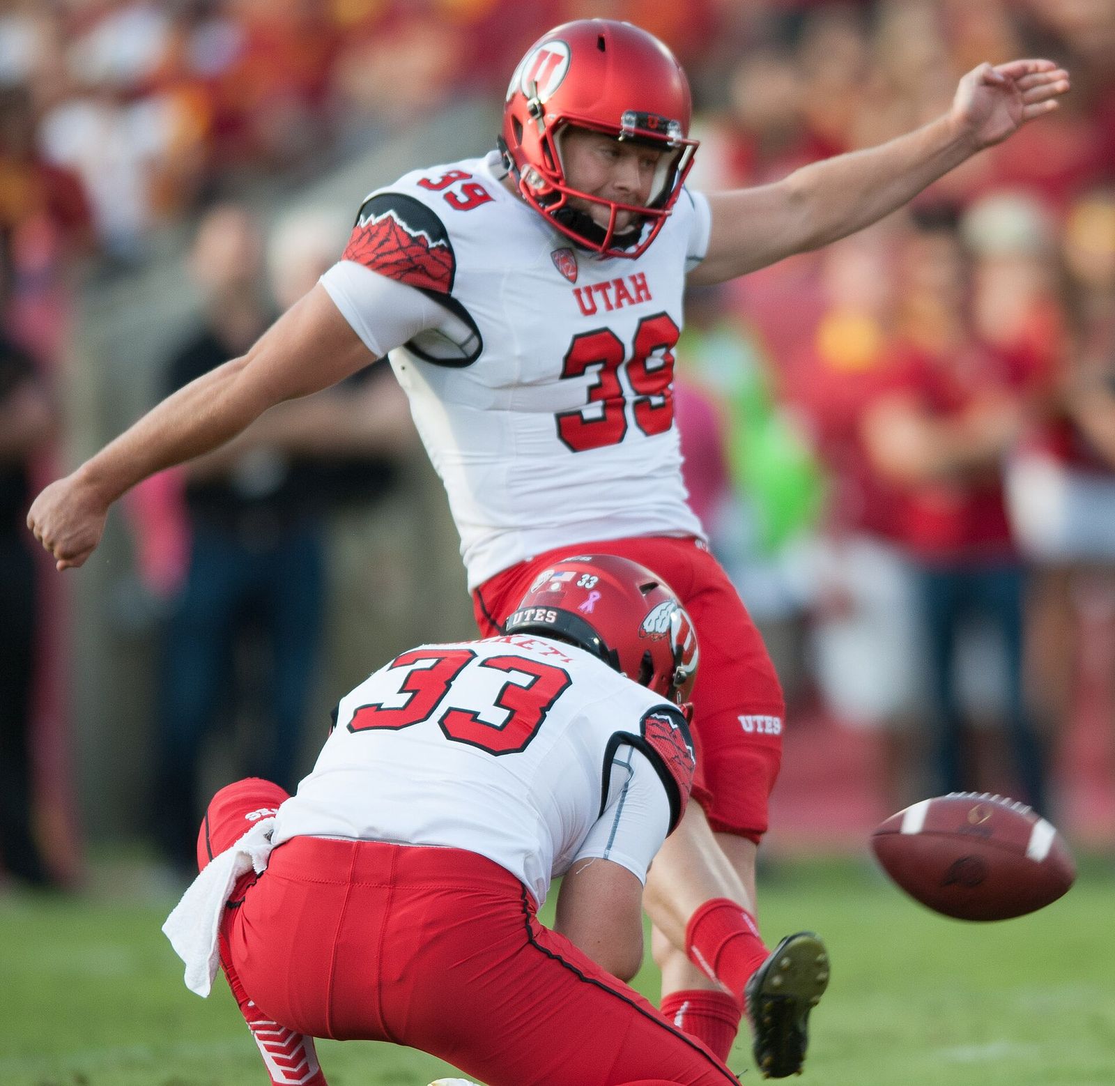 Andy Phillips kicks and Tom Hackett holds a field goal for the Utah Utes during an October 2015 game at Los Angeles Memorial Coliseum.
