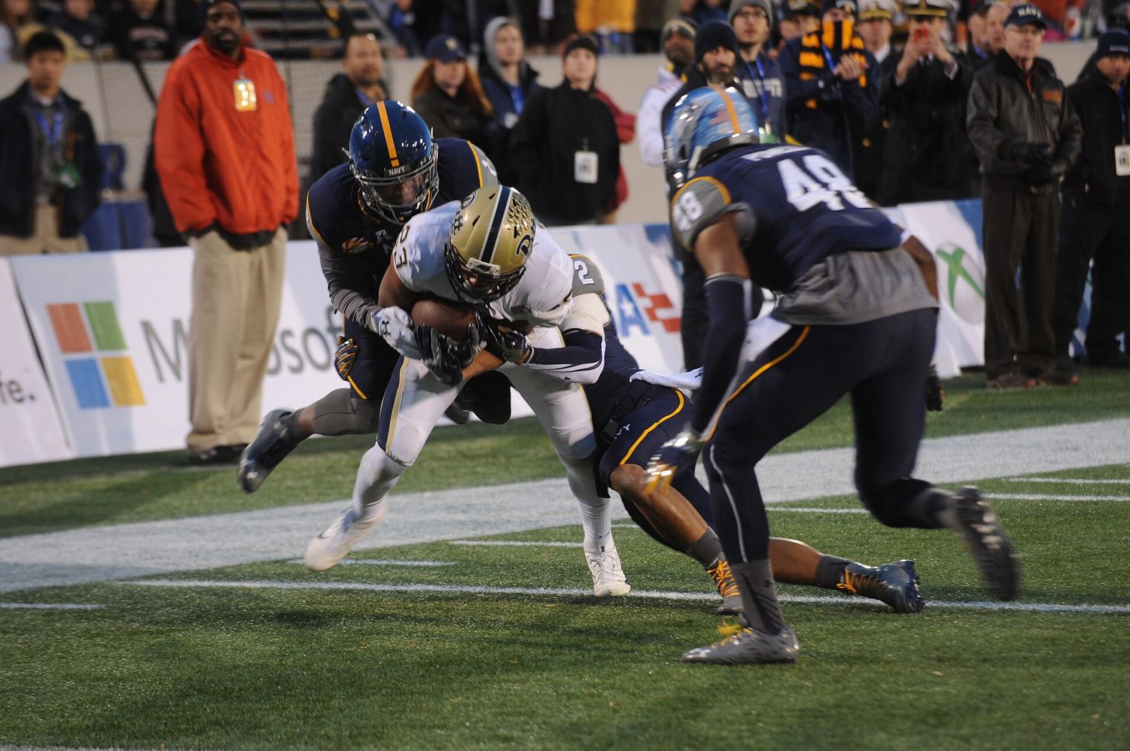 Navy Midshipmen defenders tackle Pitt wide receiver Tyler Boyd during the 2015 Military Bowl.