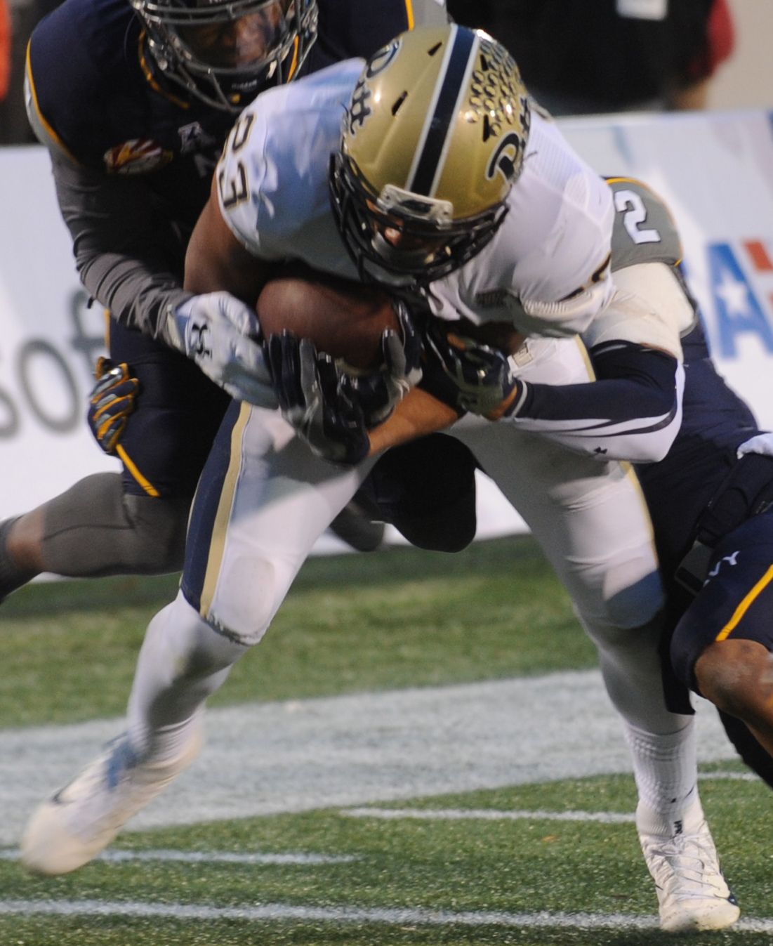 Navy Midshipmen defenders tackle Pitt wide receiver Tyler Boyd during the 2015 Military Bowl.