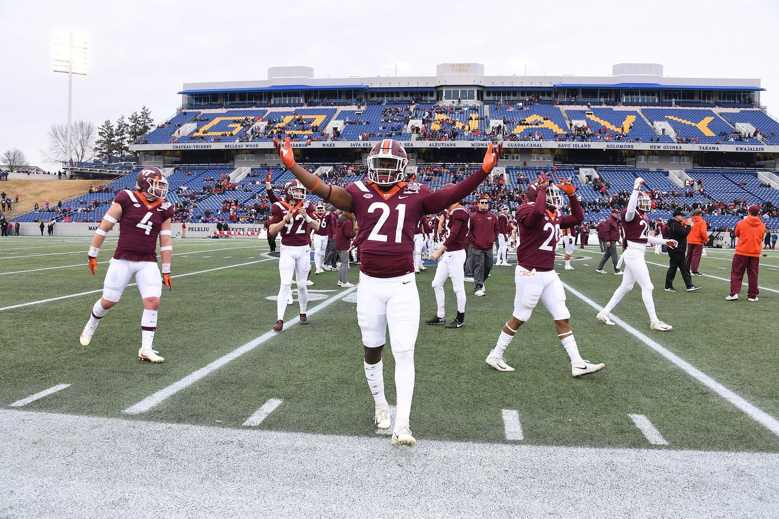 Reggie Floyd (#21) and other Virginia Tech players pump up the crowd prior to the 2018 Military Bowl.