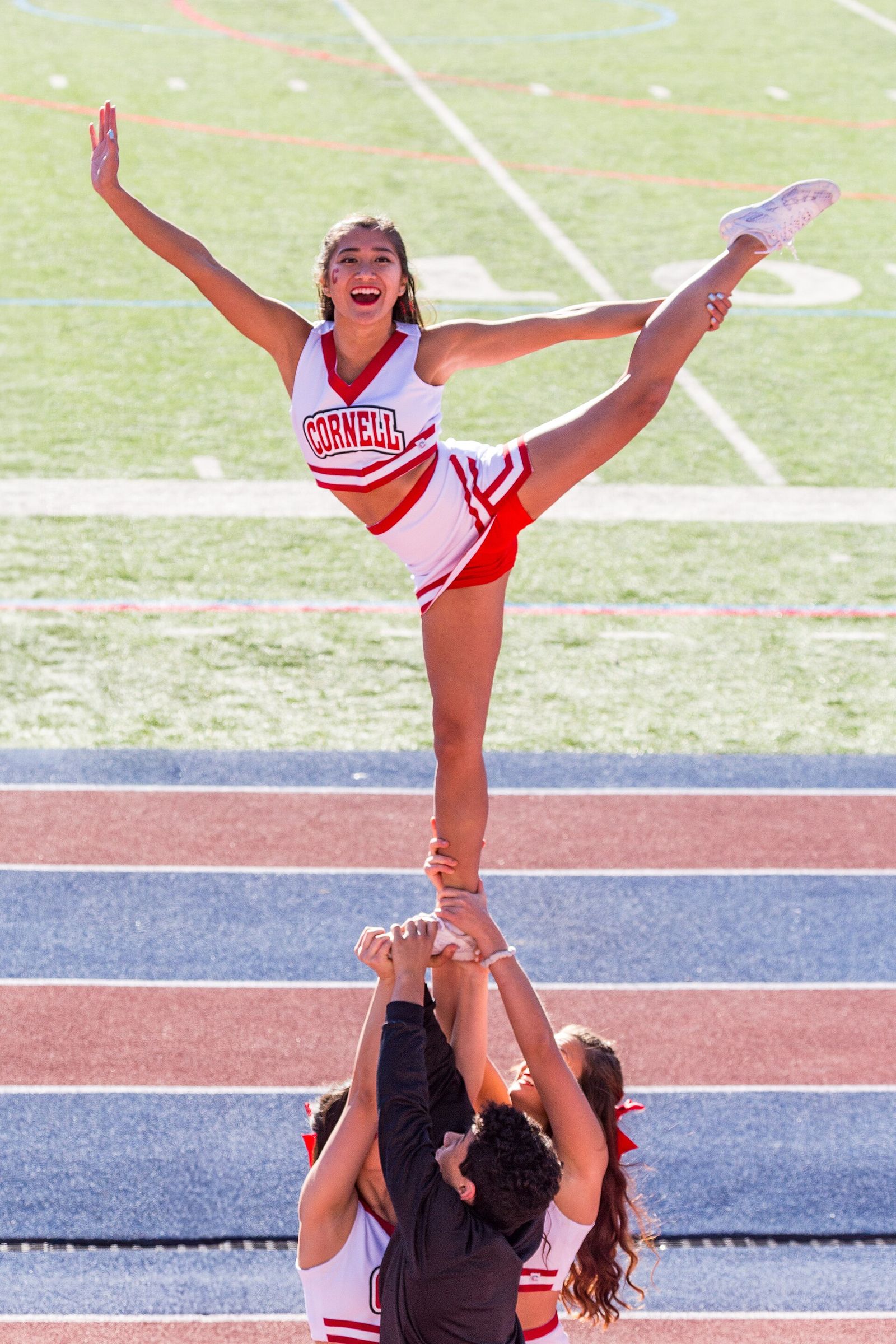 Cornell University cheerleaders execute the "Liberty" stunt at Cornell-Penn game, 2019.