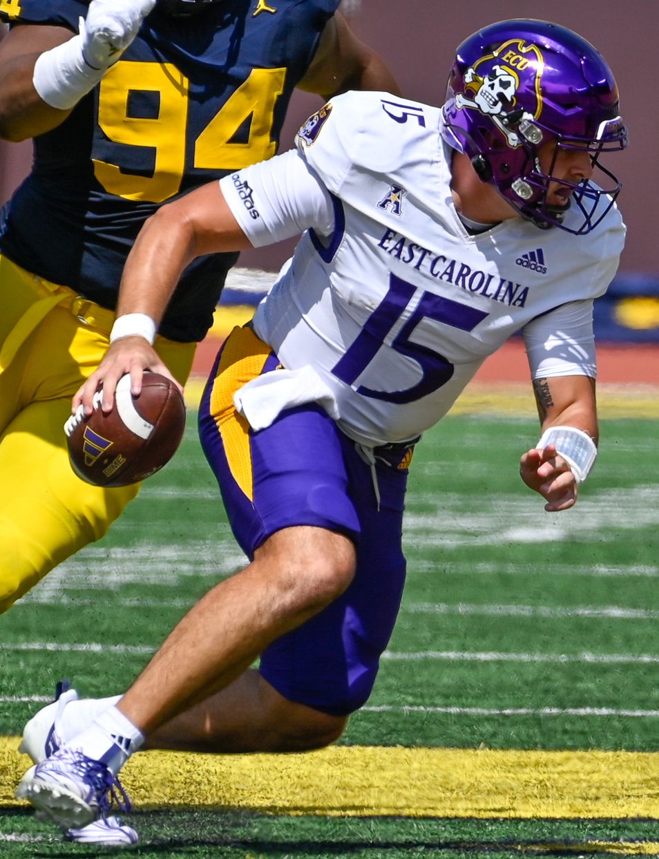 Alex Flinn of East Carolina is pursued by Michigan defenders during a September 2, 2023 game at Michigan Stadium