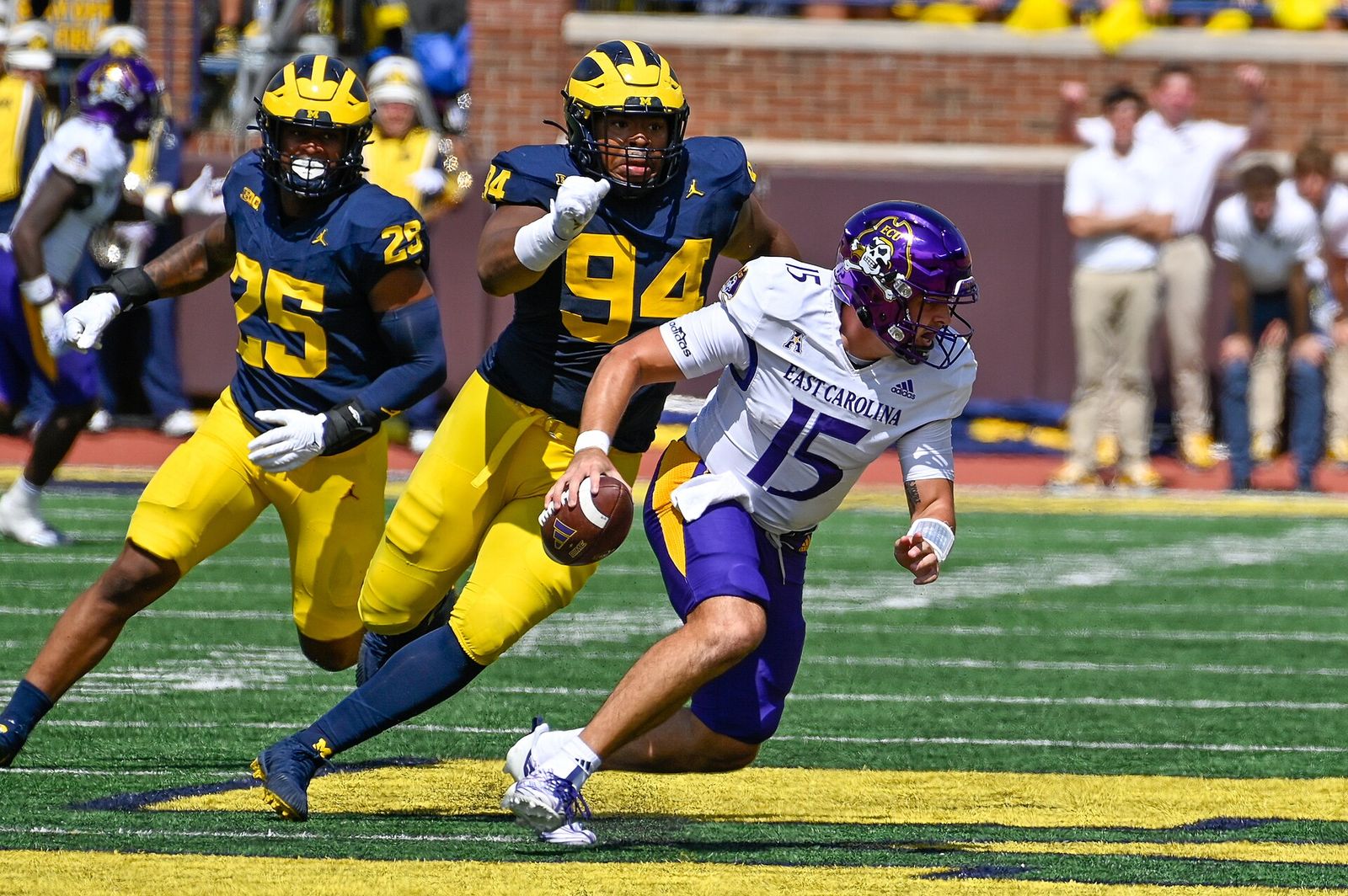 Alex Flinn of East Carolina is pursued by Michigan defenders during a September 2, 2023 game at Michigan Stadium