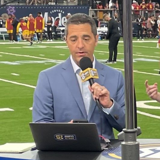 Dari Nowkhah, reading a report on the sideline of Allegiant Stadium before the 2024 Vegas Kickoff Classic for the SEC Network.