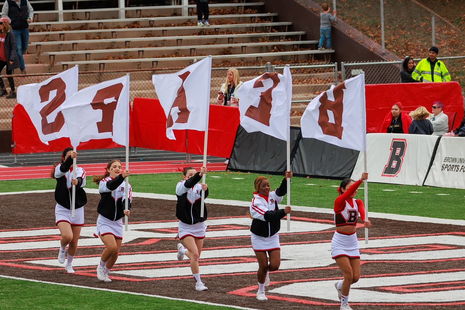 Brown University Cheerleaders bring out flags with the letters B - E - A - R - S after a touchdown. Penn Quakers at Brown Bears football (November 2, 2024)