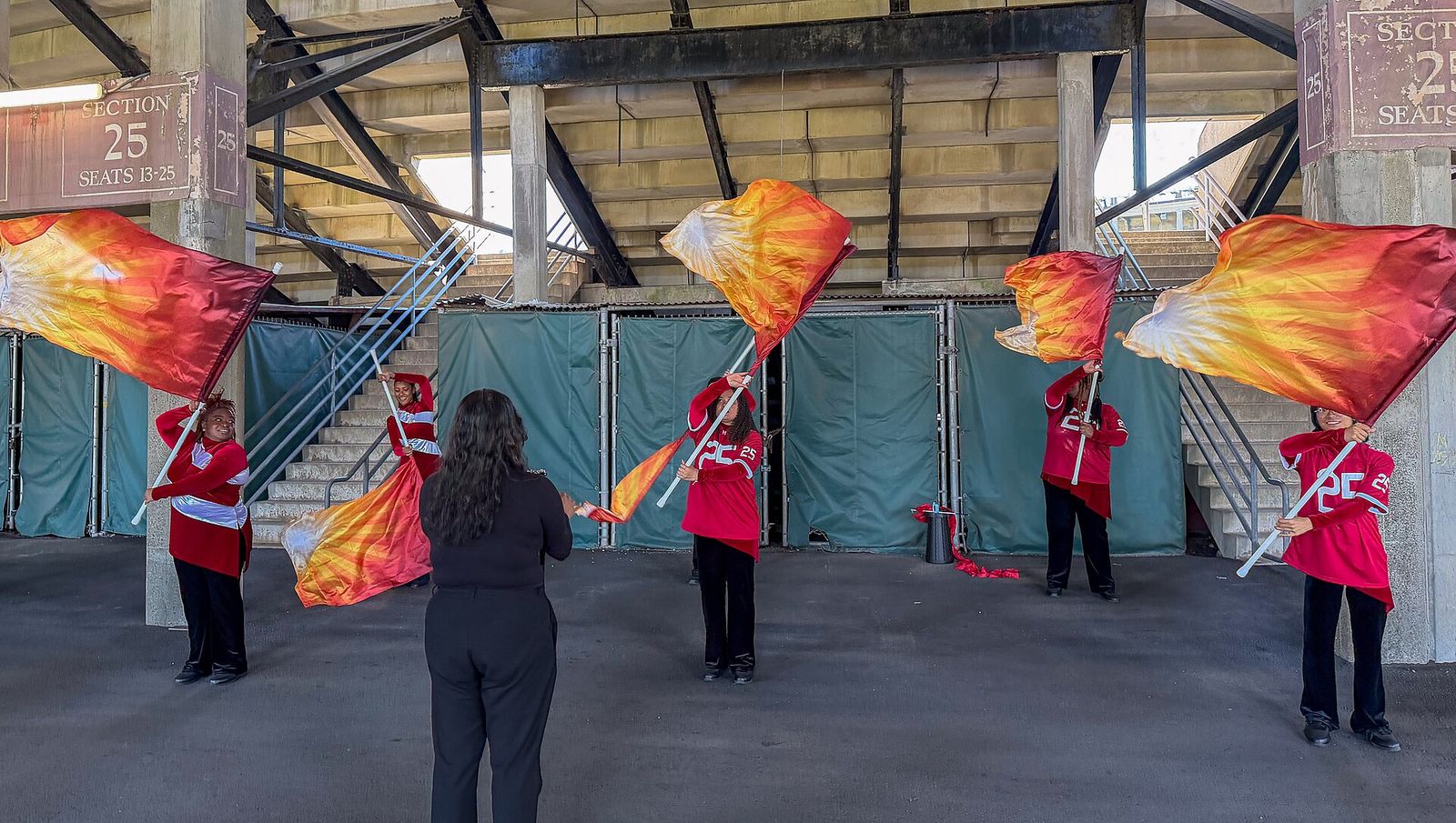 The brand new Harvard University Band Color Guard practices in Harvard Stadium before halftime.