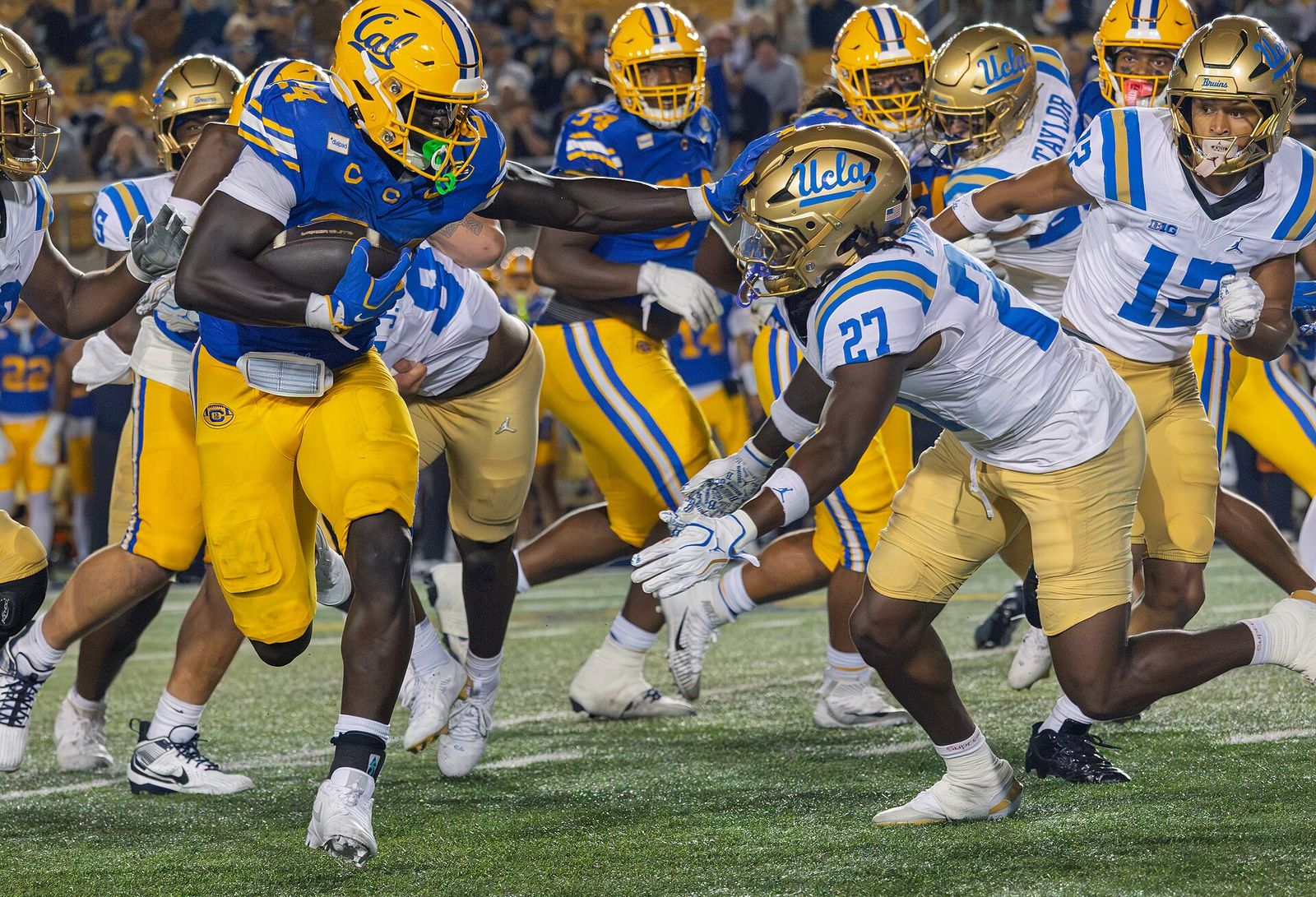 Adam Mohammed stiff-arms Ta'Shawn James at the UCLA Bruins at California Golden Bears football game on September 5, 2026
