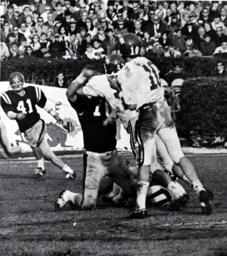 Bill Montgomery of Arkansas (white jersey) attempting a pass