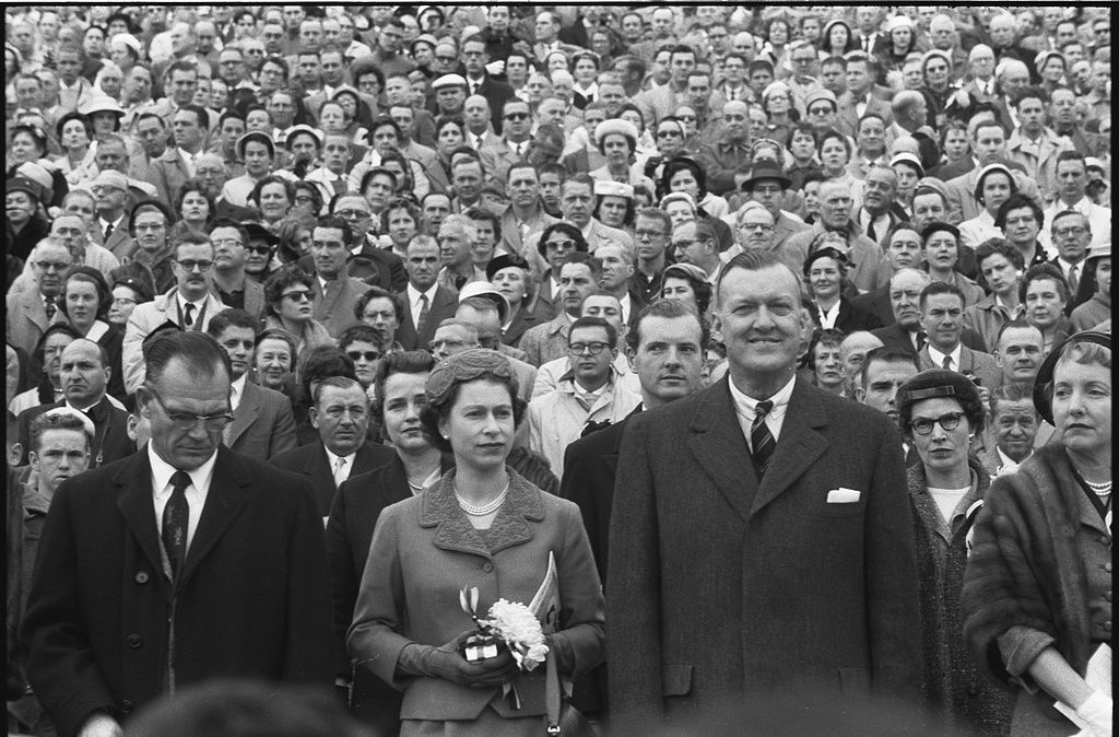 Queen Elizabeth II with Maryland governor Theodore McKeldin (right) and University of Maryland president Wilson Homer "Bull" Elkins (left), at a Maryland Terrapins vs. the North Carolina Tar Heels football game in College Park, Maryland