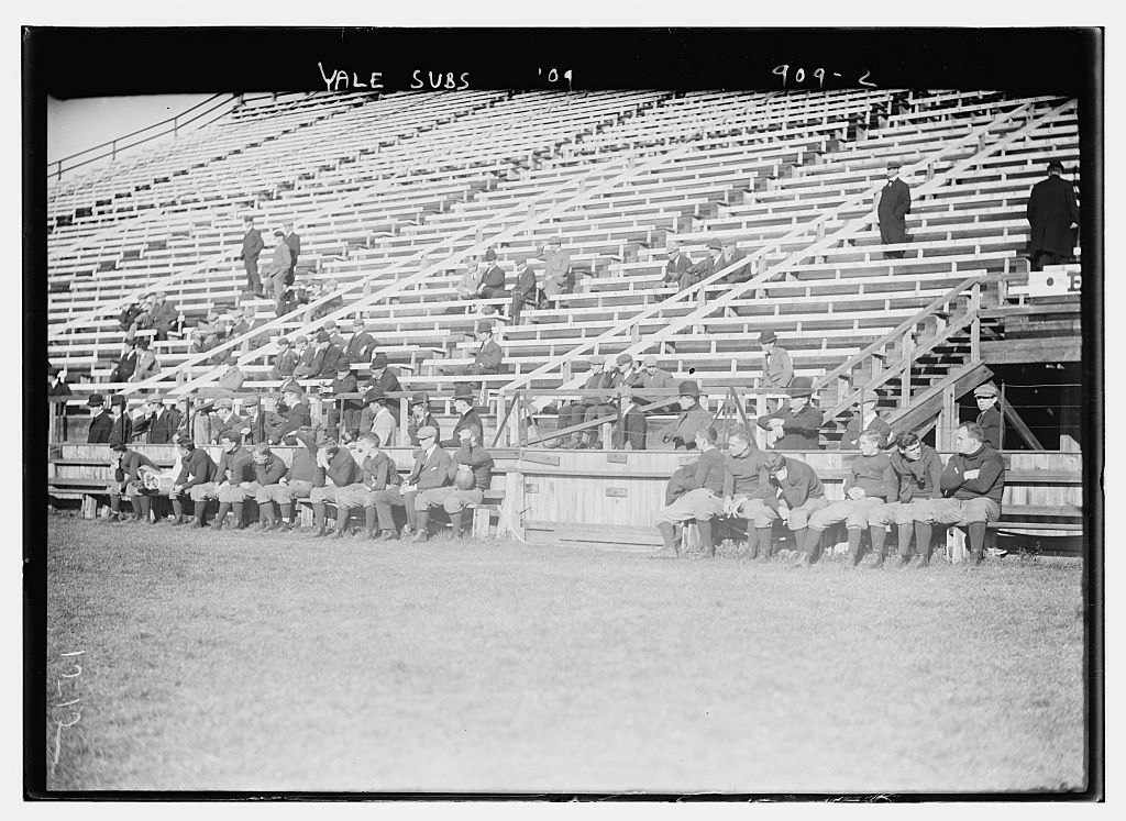 Substitutes for Yale Varsity football team on bench, New Haven, Conn.