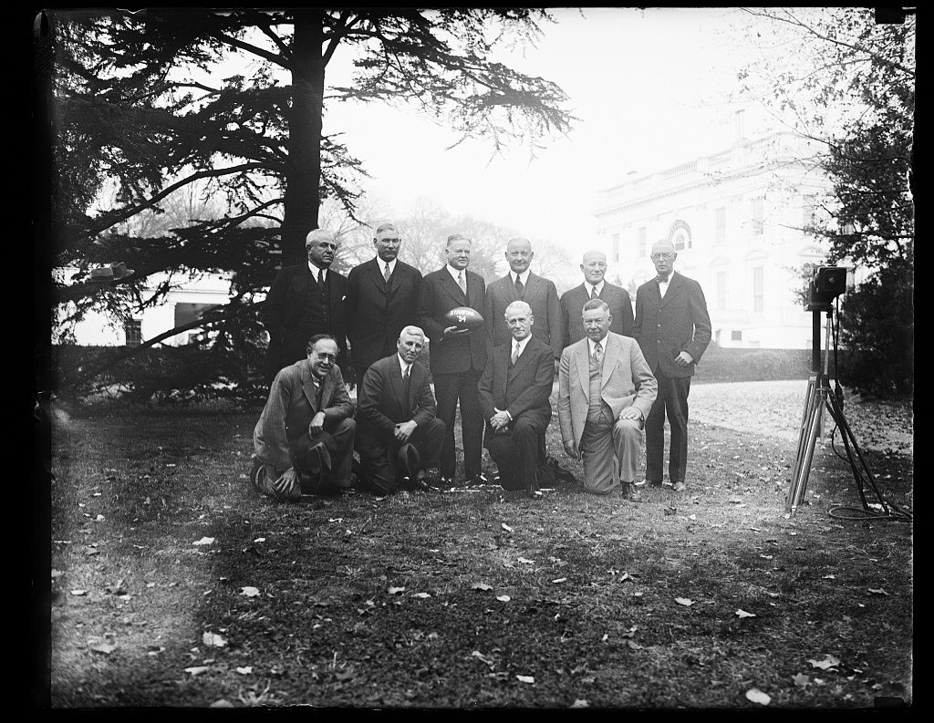 Herbert Hoover, holding Stanford football; with group at White House, Washington, D.C.