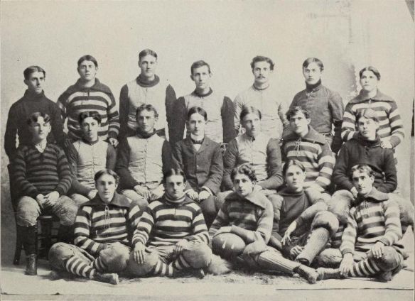 Team captain Hayes at front center, holding football